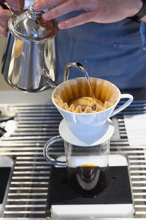 Barista making drip coffee in coffee shopの写真素材
