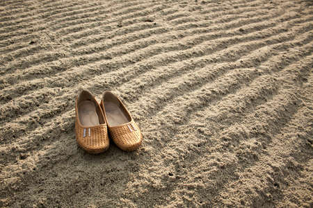 A pair of shoes on a sandy beachの写真素材