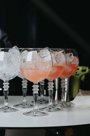 Cocktails with champagne in wine glasses on the bar table in the pub or restaurant.の写真素材