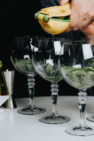 Cocktails with champagne in wine glasses on the bar table in the pub or restaurant with the bartender.の写真素材