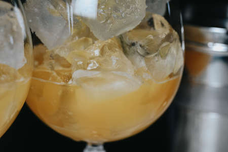 Cocktails with champagne in wine glasses on the bar table in the pub or restaurant.の写真素材