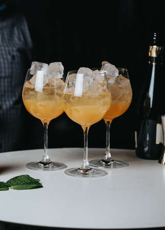 Cocktails with champagne in wine glasses on the bar table in the pub or restaurant.の写真素材