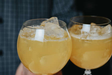 Cocktails with champagne in wine glasses on the bar table in the pub or restaurant.の写真素材
