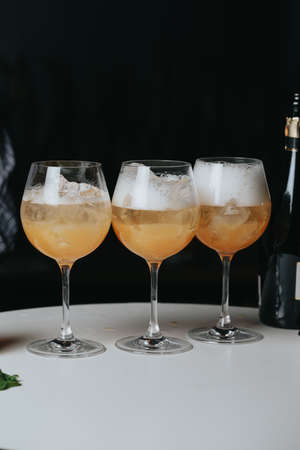 Cocktails with champagne in wine glasses on the bar table in the pub or restaurant.の写真素材