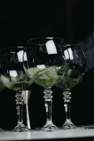 Cocktails with champagne in wine glasses on the bar table in the pub or restaurant.