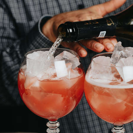 Cocktails with champagne in wine glasses on the bar table in the pub or restaurant.の写真素材
