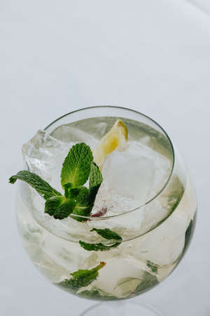 Cocktails with champagne in wine glasses on the bar table in the pub or restaurant with the bartender.の写真素材