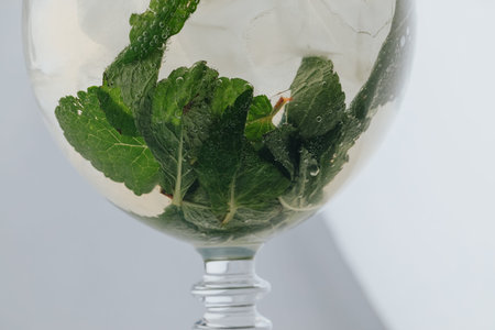 Cocktails with champagne in wine glasses on the bar table in the pub or restaurant with the bartender.の写真素材