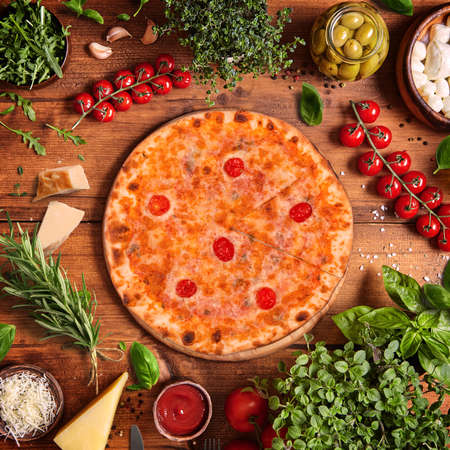 Italian PIZZA top view with vegetables backgroundの写真素材
