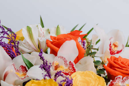 Ceramic vase with roses, cymbidium, alstroemeria and greenery.の写真素材