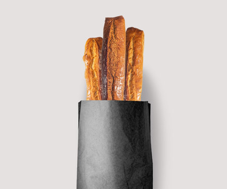 Fresh bread baked with seeds in a kraft paper bag, natural, white or black!の写真素材