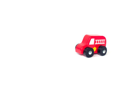 Red wooden fire engine toy isolated over a white background