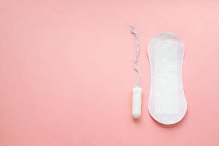 women intimate hygiene products - sanitary pads and tampon on pink background.の写真素材