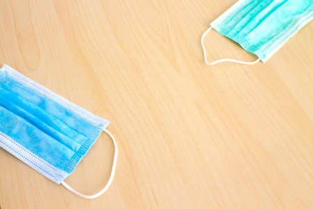 Top view of fabric green and blue surgical medical face mask and two handmade maskの写真素材