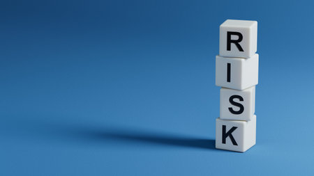 Word risk on wooden cubes with copy space.close up of wooden elements,Business Concept.3D rendering on blue background.の写真素材