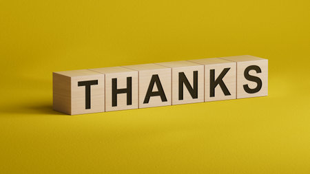 3D illustration of "THANKS" in English, using a classic font. It conveys deep gratitude and is ideal for elegant messaging.wooden cubes.3D rendering on YELLOW background.の写真素材