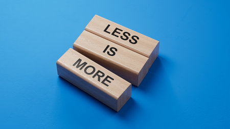Less is More symbol. Concept words Less is More on wooden blocks. Business and Less is More concept. Copy space.3D rendering on blue background.の写真素材