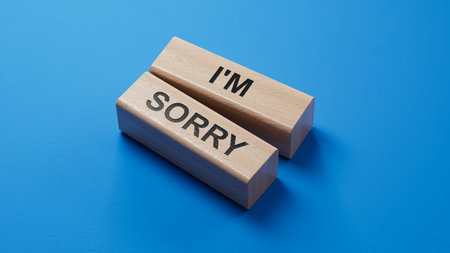 3D illustration of I'M SORRY in English, using a heartfelt font. It symbolizes sincere remorse and apology.blue Cut Out Paper.3D rendering on blue background.の写真素材