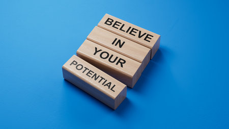 Believe in your potential message written on wooden blocks. Conceptual believe in your potential symbol. Copy space.3D rendering on blue background.の写真素材