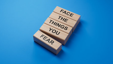Face the things you fear symbol. wooden blocks with words Face the things you fear.Business and Face the things you fear concept.3D rendering on blue background.の写真素材