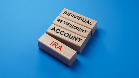 IRA - Individual Retirement Account symbol. Concept word IRA on wooden blocks.Business and IRA concept. Copy space.3D rendering on blue background.の写真素材