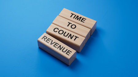 Time to count Revenue symbol. wooden blocks with words Time to count Revenue.Business and Time to count Revenue concept. Copy space.3D rendering on blue background.の写真素材