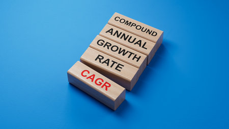 wooden blocks with the letters CAGR . the inscription on the cubes is reflected from the surface. CAGR - Compound Annual Growth Rate.3D rendering on blue background.の写真素材