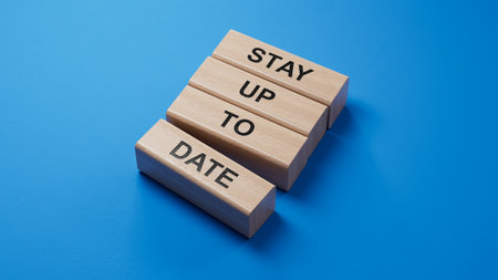 Text STAY UP TO DATE writing in wooden blocks. Business concept. wooden blocks. Copy space.3D rendering on blue background.の写真素材