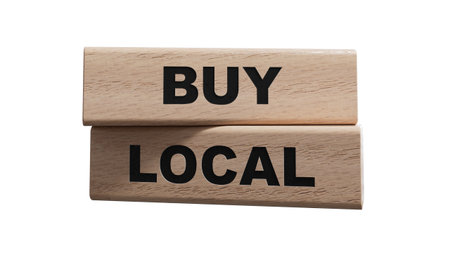 buy local symbol. wooden blocks with words 'Buy local'. Beautiful orange background. Business and time to buy local concept. Copy space.の写真素材