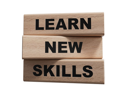 Learn new skills symbol. Concept words Learn new skills on wooden blocks.Business and Learn new skills concept. Copy space.Supports PNG files with transparent backgrounds.の写真素材