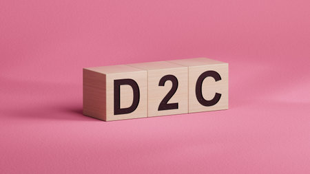 three stone wooden cubes, tables with the word D2C - acronym Direct to Consumer. close up of wooden...