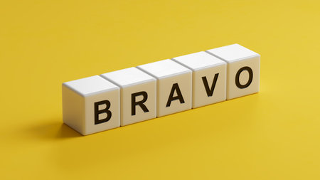 The word bravo appearing wooden cubes. Education concept.close up of wooden cubes,Business Concept.3D rendering on yellow background.の写真素材