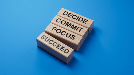 Decide Commit Focus Succeed symbol. Concept words Decide Commit Focus Succeed on wooden blocks.Business concept. Copy space.3D rendering on blue background.の写真素材