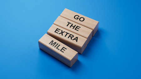 Go the extra mile symbol. wooden blocks with words Go the extra mile.Business and Go the extra mile concept. Copy space.3D rendering on blue background.の写真素材