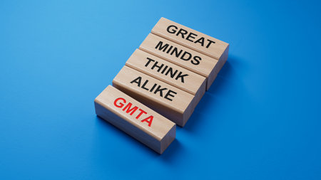 Closeup wood cubes into the row to complete the word gmta, GREAT MINDS THINK ALIKE.3D rendering on...