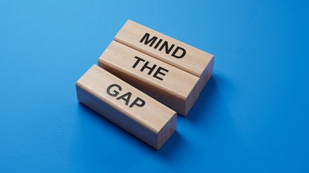 Mind the gap symbol. Concept words Mind the gap.Business and Mind the gap concept. wooden blocks. Copy space.3D rendering on blue background.の写真素材