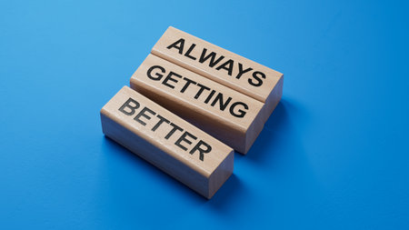 Always getting better symbol. wooden blocks with words Always getting better.Business and Always getting better concept.Copy space.3D rendering on blue background.の写真素材
