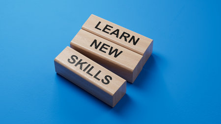 Learn new skills symbol. Concept words Learn new skills on wooden blocks.Business and Learn new skills concept. Copy space.3D rendering on blue background.の写真素材