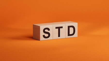STD Sexually transmitted infections text on wooden cubes. medical concept.close up of wooden cubes.3D rendering on orange background.の写真素材