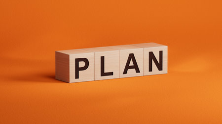 Flat lay view from above on wooden cubes spelling 'PLAN'. 3D rendering on orange background.の写真素材