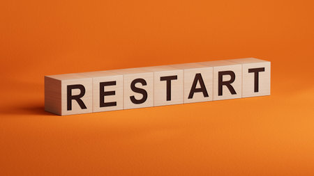 Wooden Blocks with the text: Restart. New business relaunch startup concept. 3D rendering on orange background.の写真素材