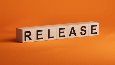 The word release written on wooden cubess. Business and finance concept.close up of wooden cubes,Business Concept.3D rendering on orange background.の写真素材
