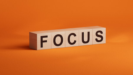 wooden cubes with FOCUS business word.close up of wooden cubes,Business Concept.3D rendering on orange background.の写真素材