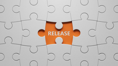 The word release written on The white puzzle pieces with missing pieces. Business and finance concept.close up of The white puzzle pieces with missing pieces,Business Concept.3D rendering on orange background.の写真素材