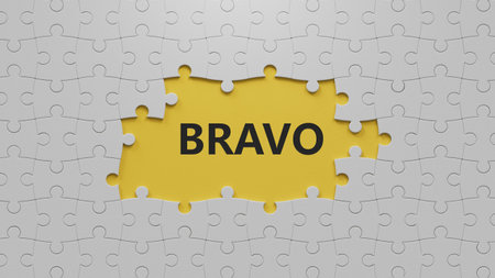 The word bravo appearing The white puzzle pieces with missing pieces. Education concept.close up of The white puzzle pieces with missing pieces,Business Concept.3D rendering on yellow background.の写真素材