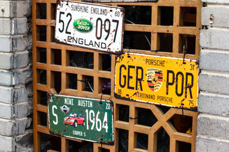 Old plate hanging from the windowのeditorial素材