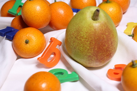 Kumquat, pears, lettersの写真素材
