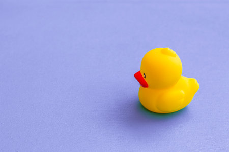 Rubber duck on purple backgroundの写真素材