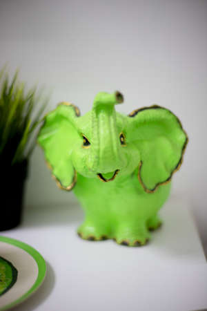 OMSK, RUSSIA, MAY 08, 2020: Green elephant figurine. It`s on the shelf. Front view.のeditorial素材