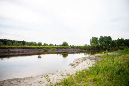 View of the Tara river, Omsk region, Siberia, Russia. Surroundings of the Siberian expanses. Picturesque view on the steep Bank of the river.の写真素材